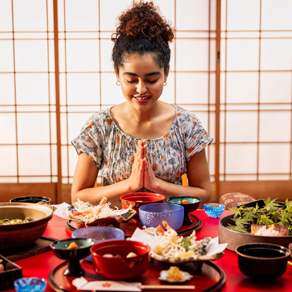 Kagurazaka Kaga Tokyo. Woman with a table of food