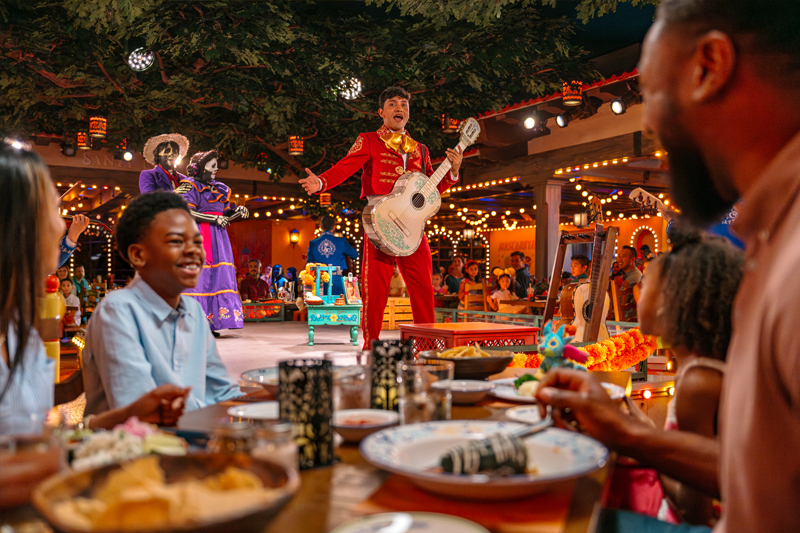 Family enjoying dining at Plaza de Coco aboard the Disney Treasure cruise